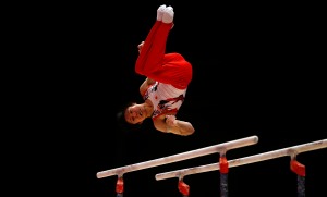 Japan's Kohei Uchimura performs on the parallel bars as he takes part in the men's qualification competition at the World Artistic Gymnastics championships in Glasgow, Scotland, Sunday, Oct. 25, 2015. (AP Photo/Matthias Schrader)